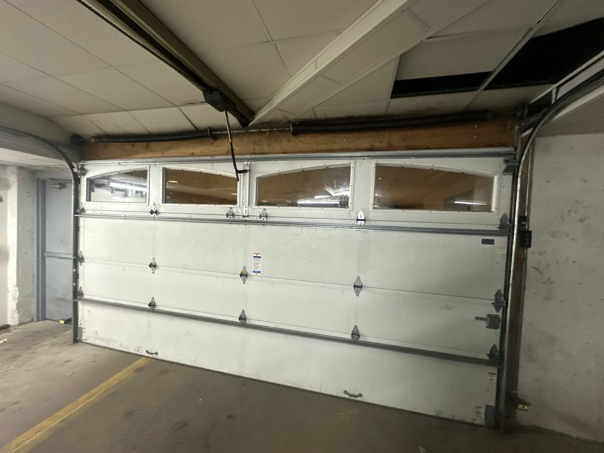 Commercial sectional door with arched windows interior view with torsion spring