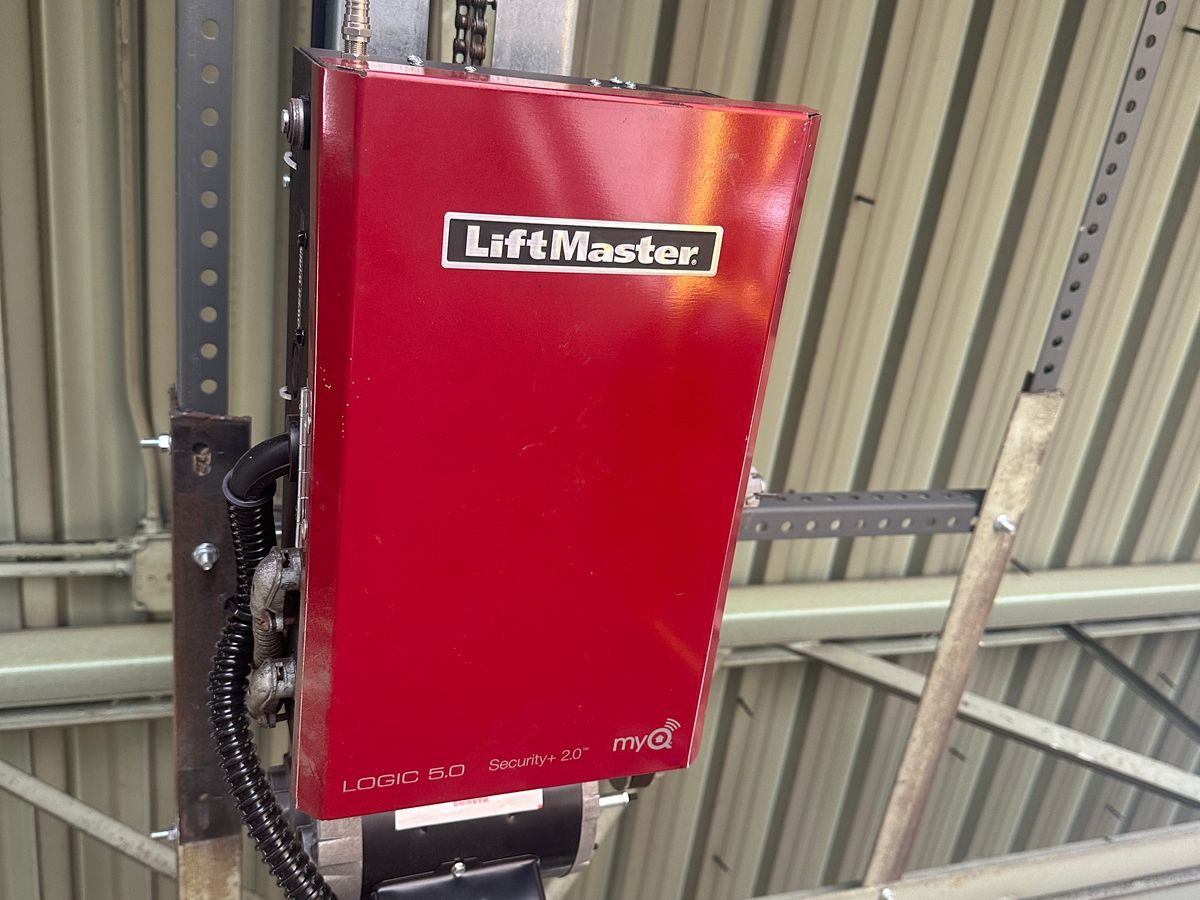 Red LiftMaster Logic 5.0 commercial opener with MyQ installed on commercial track